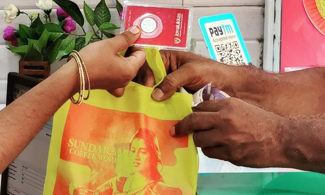 Two pairs of hands meeting over the counter as the tote changes hands